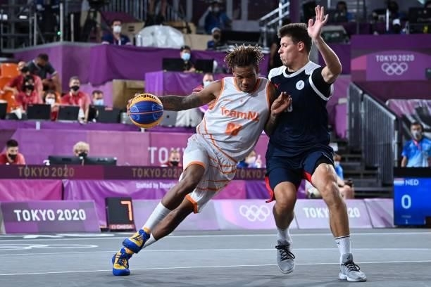 Netherlands' Jessey Voorn fights for the ball with Russia's Kirill Pisklov during the men's first round 3x3 basketball match between Netherlands and...