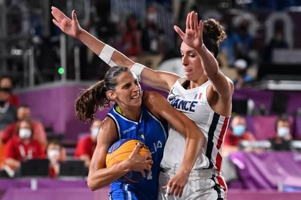 Italy's Chiara Consolini fights for the ball with France's Laetitia Guapo during the women's first round 3x3 basketball match between France and...