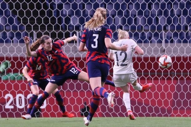 New Zealand's midfielder Betsy Hassett scores the third goal during the Tokyo 2020 Olympic Games women's group G first round football match between...