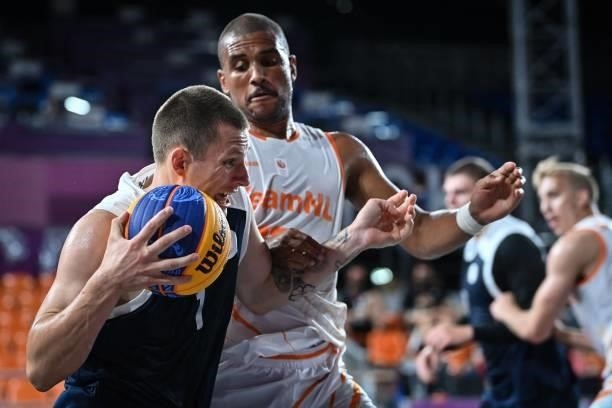 Russia's Stanislav Sharov fights for the ball with Netherlands' Dimeo Van Der Horst during the men's first round 3x3 basketball match between...