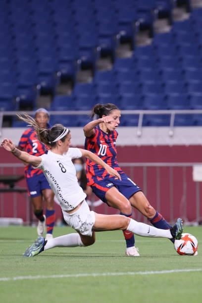 S forward Carli Lloyd attempts a shot as she is marked by New Zealand's defender Abby Erceg during the Tokyo 2020 Olympic Games women's group G first...