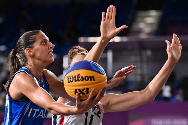 Italy's Chiara Consolini fights for the ball with France's Ana Maria Filip during the women's first round 3x3 basketball match between France and...