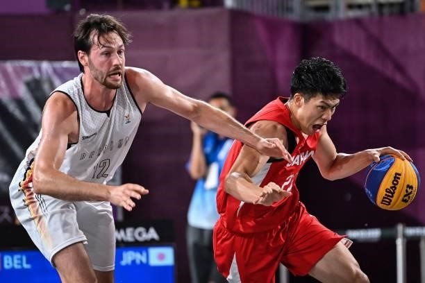 Belgium's Thierry Marien fights for the ball with Japan's Ryuto Yasuoka during the men's first round 3x3 basketball match between Belgium and Japan...