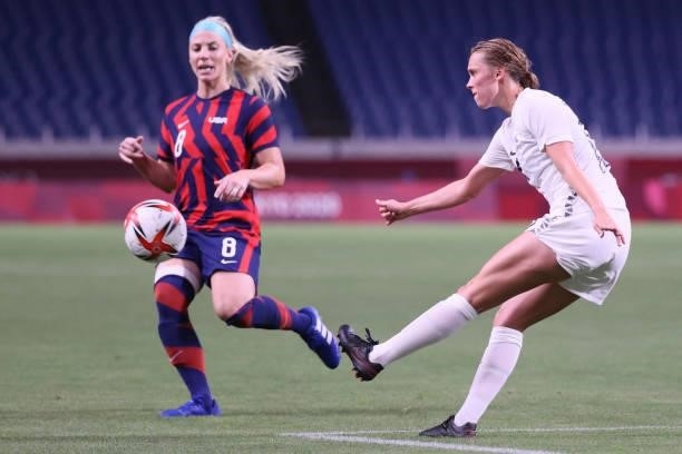 New Zealand's midfielder Daisy Cleverley clears the ball as she is marked by USA's midfielder Julie Ertz during the Tokyo 2020 Olympic Games women's...