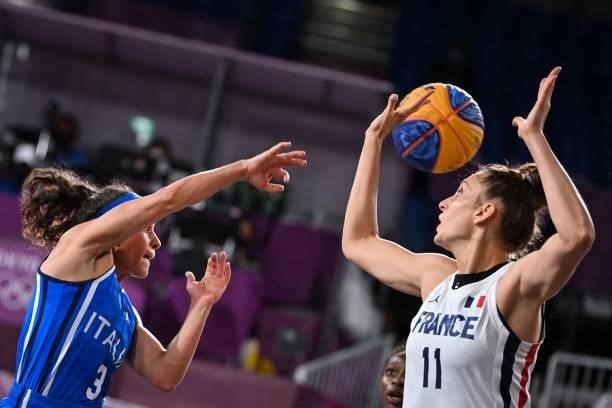 Italy's Raelin D Alie fights for the ball with France's Ana Maria Filip during the women's first round 3x3 basketball match between France and Italy...