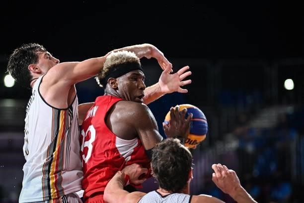 Japan's Ira Brown controls the ball during the men's first round 3x3 basketball match between Belgium and Japan at the Aomi Urban Sports Park in...