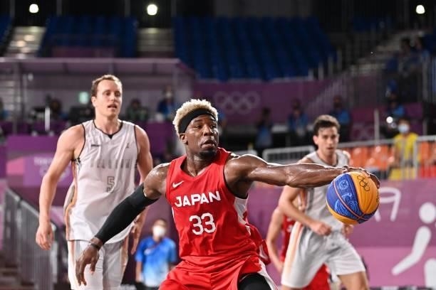 Japan's Ira Brown dribbles the ball during the men's first round 3x3 basketball match between Belgium and Japan at the Aomi Urban Sports Park in...
