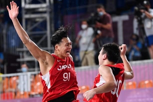 Japan's Tomoya Ochiai and Japan's Keisei Tominaga celebrate at the end of the men's first round 3x3 basketball match between Belgium and Japan at the...