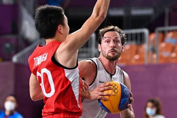 Belgium's Thierry Marien reacts as he controls the ball next to Japan's Keisei Tominaga during the men's first round 3x3 basketball match between...