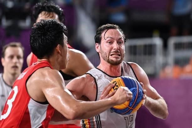 Japan's Ryuto Yasuoka fights for the ball with Belgium's Thierry Marien during the men's first round 3x3 basketball match between Belgium and Japan...