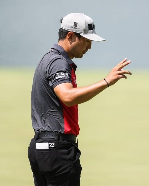 Alex Kang acknowledges the crowd after sinking his putt on the 8th green during the third round of the Price Cutter Charity Championship presented by...