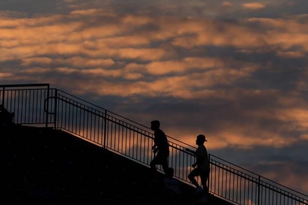 Fans walk up the steps during the sixth inning as the sun sets in a game between the Atlanta Braves and Philadelphia Phillies at Citizens Bank Park...