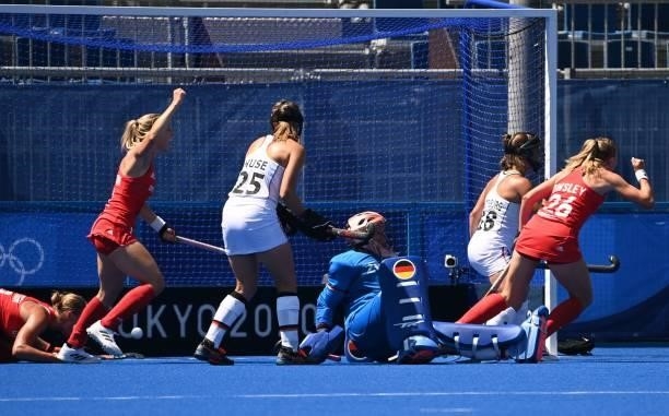 Britain's players celebrate after teammate Britain's Sarah Louise Jones opened the score against Germany during their women's pool A match of the...
