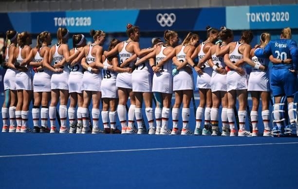 Players of Germany get together to listen to their anthem before their women's pool A match of the Tokyo 2020 Olympic Games field hockey competition...