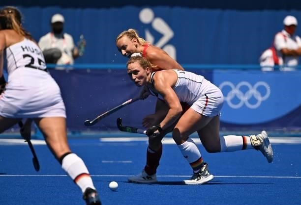 Germany's Nike Lorenz is marked by Britain's Hannah Martin during their women's pool A match of the Tokyo 2020 Olympic Games field hockey...