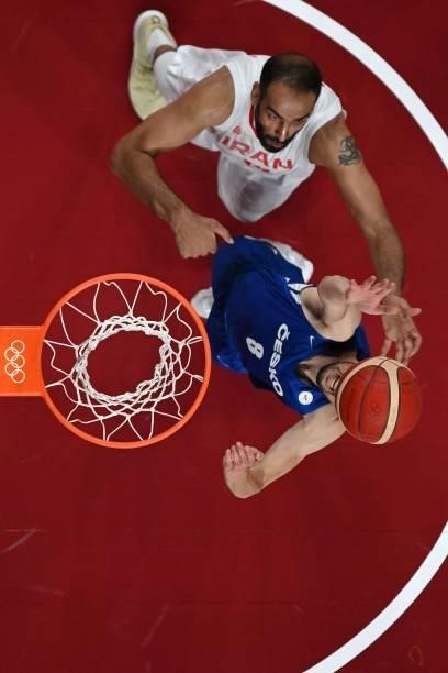 Czech Republic's Tomas Satoransky goes to the basket as Iran's Hamed Haddadi watches in the men's preliminary round group A basketball match between...