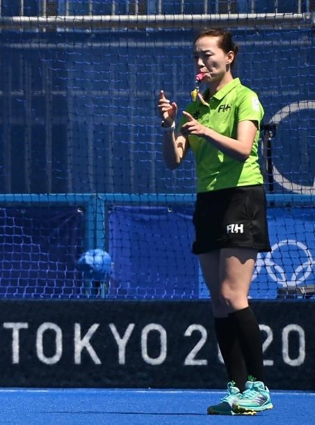 Chinese umpire Liu Xiaoying awards a goal during the women's pool A match of the Tokyo 2020 Olympic Games field hockey competition between Britain...
