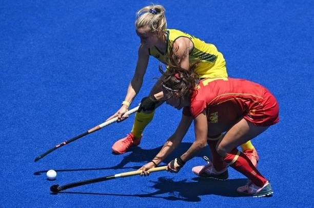 Spain's Julia Pons and Australia's Stephanie Anna Kershaw vie for the ball during their women's pool B match of the Tokyo 2020 Olympic Games field...