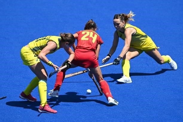 Spain's Alejandra Torres-Quevedo is tackled by Australia's Renee Taylor and Greta Hayes during their women's pool B match of the Tokyo 2020 Olympic...