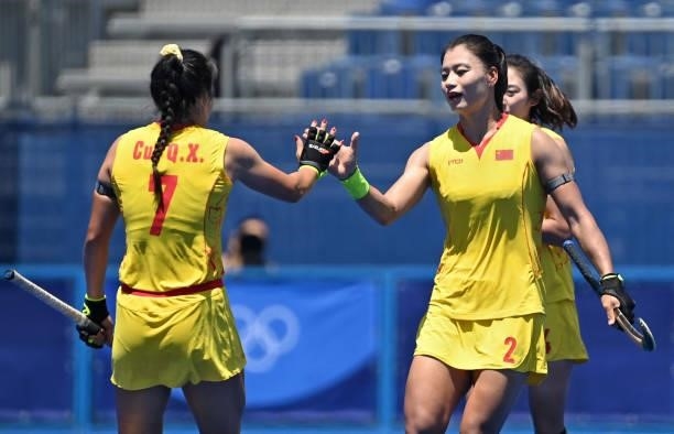 China's Gu Bingfeng celebrates with teammate Cui Qiuxia after scoring against Japan during their women's pool B match of the Tokyo 2020 Olympic Games...