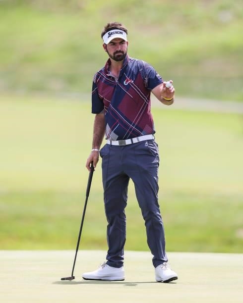 Brett Drewitt of Australia acknowledges the crowd after sinking his putt on the 18th green during the third round of the Price Cutter Charity...