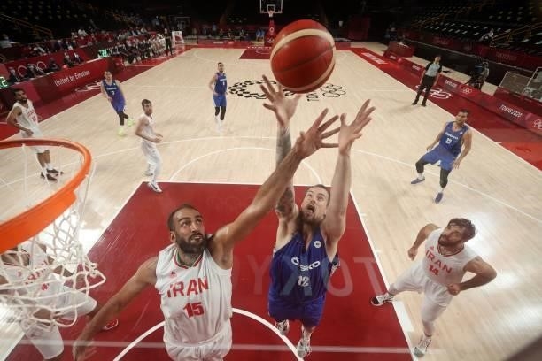 Iran's Hamed Haddadi and Czech Republic's Ondrej Balvin jump for the rebound in the men's preliminary round group A basketball match between Iran and...