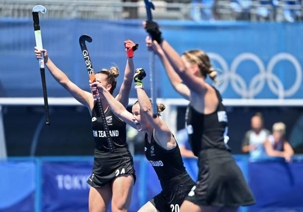 New Zealand's Rose Keddell, Megan Hull and Olivia Merry celebrate after scoring against Argentina during their women's pool B match of the Tokyo 2020...