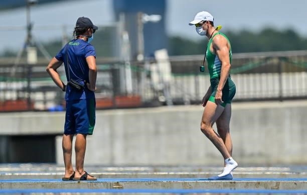 Tokyo , Japan - 25 July 2021; Philip Doyle of Ireland, right, with coach Giuseppe Devita, after finishing in last place with team-mate Ronan Byrne in...