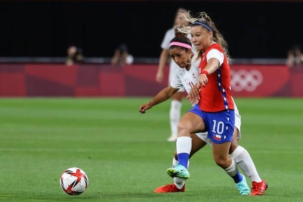 Desiree SCOTT of Team Canada battles for possession with Yanara AEDO of Team Chile during the Women's First Round Group E match between Chile and...