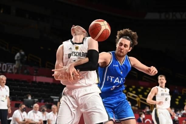 Italy's Alessandro Pajola fights for the ball in the men's preliminary round group B basketball match between Germany and Italy during the Tokyo 2020...