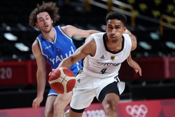 Germany's Maodo Lo runs with the ball past in the men's preliminary round group B basketball match between Germany and Italy during the Tokyo 2020...