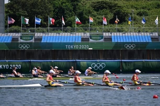 Athletes compete in front of empty stands at the women's four repechage during the Tokyo 2020 Olympic Games at the Sea Forest Waterway in Tokyo on...