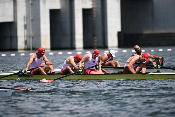 Switzerland's Paul Jacquot, Switzerland's Markus Kessler, Switzerland's Joel Schuerch and Switzerland's Andrin Gulich react after the men's four...