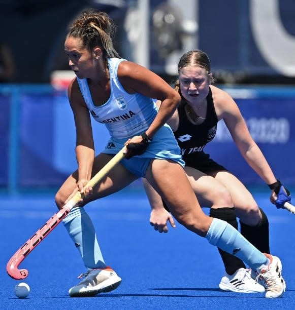 Argentina's Rocio Sanchez Moccia carries the ball past New Zealand's Hope Ralph during their women's pool B match of the Tokyo 2020 Olympic Games...