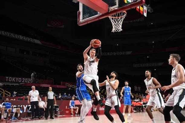 Germany's Robin Benzing goes to the basket in the men's preliminary round group B basketball match between Germany and Italy during the Tokyo 2020...