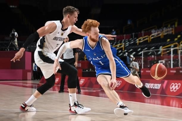 Italy's Niccolo Mannion dribbles the ball in the men's preliminary round group B basketball match between Germany and Italy during the Tokyo 2020...
