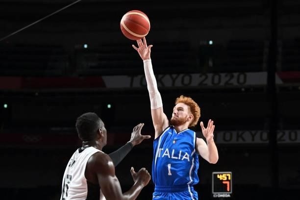 Italy's Niccolo Mannion jumps for the ball in the men's preliminary round group B basketball match between Germany and Italy during the Tokyo 2020...