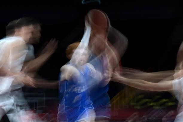 German players fight for the ball with an Italian player in the men's preliminary round group B basketball match between Germany and Italy during the...
