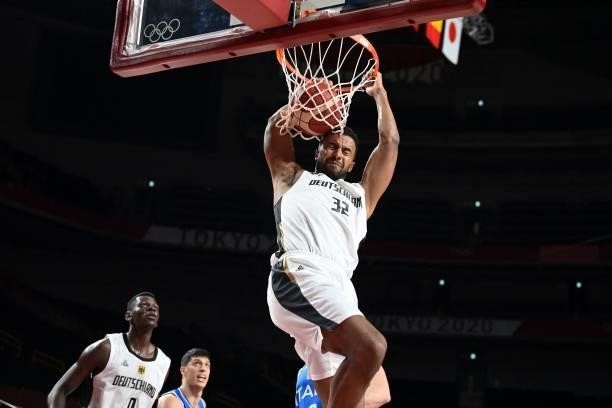 Germany's Johannes Thiemann dunks the ball in the men's preliminary round group B basketball match between Germany and Italy during the Tokyo 2020...