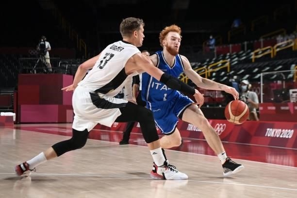 Italy's Niccolo Mannion dribbles the ball past Germany's Moritz Wagner in the men's preliminary round group B basketball match between Germany and...