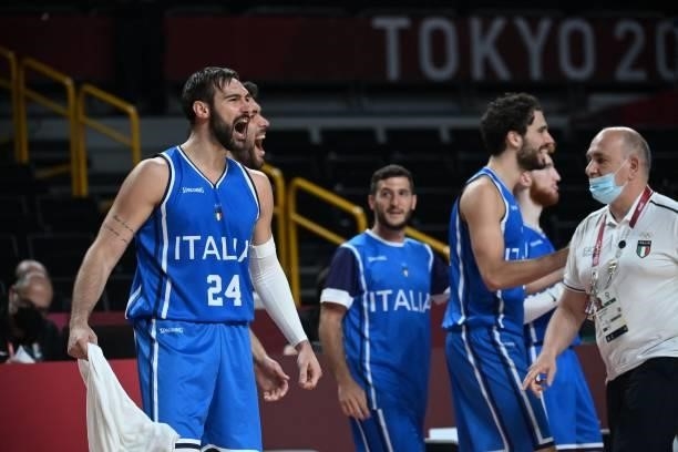 Italian players celebrate after their win in the men's preliminary round group B basketball match between Germany and Italy during the Tokyo 2020...