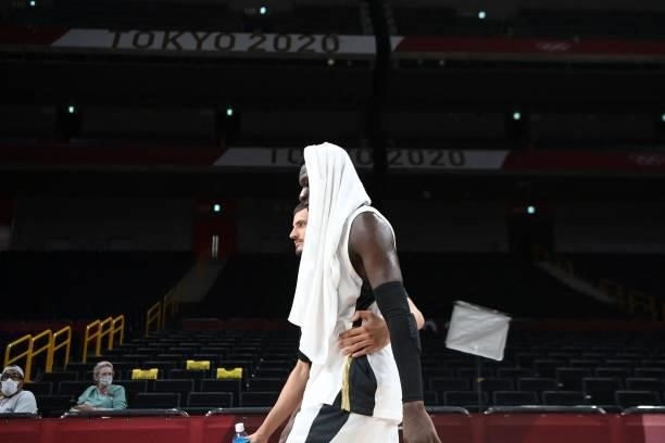 Germany's Isaac Bonga along with a teammate walks off the court after the men's preliminary round group B basketball match between Germany and Italy...