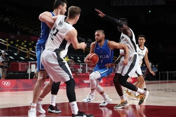Italy's Stefano Tonut runs with the ball past German players in the men's preliminary round group B basketball match between Germany and Italy during...