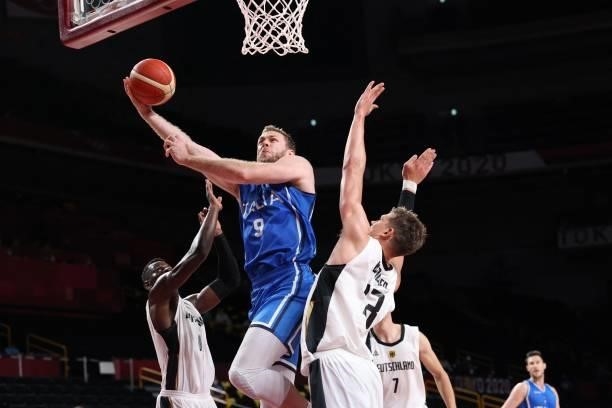 Italy's Nicolo Melli goes to the basket in the men's preliminary round group B basketball match between Germany and Italy during the Tokyo 2020...
