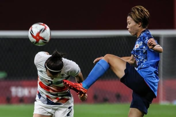 Hina SUGITA of Team Japan is challenged by Lucy BRONZE of Team Great Britain during the Women's First Round Group E match between Japan and Great...
