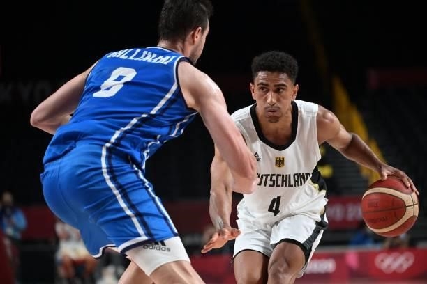 Germany's Maodo Lo dribbles the ball past Italy's Danilo Gallinari in the men's preliminary round group B basketball match between Germany and Italy...