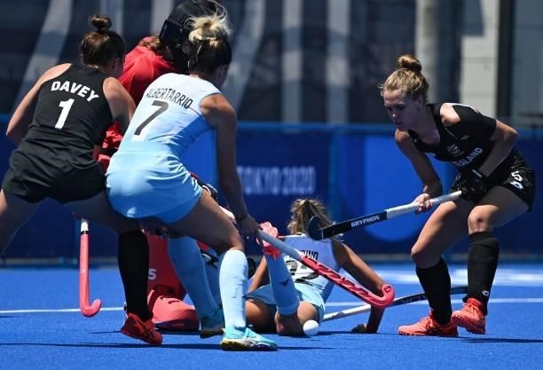 Argentina's Agustina Albertarrio is marked by New Zealand's Tarryn Davey and Frances Davies as she tries to score during their women's pool B match...