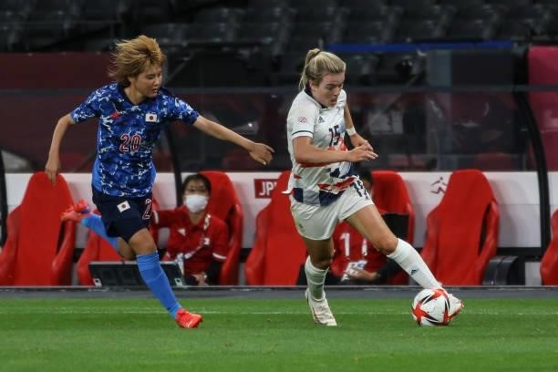 Honoka HAYASHI of Team Japan is challenged by Lauren HEMP of Team Great Britain during the Women's First Round Group E match between Japan and Great...