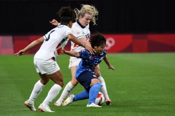 Yuka MOMIKI of Team Japan is challenged by Lauren HEMP and Demi STOKES of Team Great Britain during the Women's First Round Group E match between...