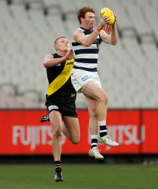 Gary Rohan of the Cats marks the ball ahead of Ryan Garthwaite of the Tigers during the 2021 AFL Round 19 match between the Geelong Cats and the...